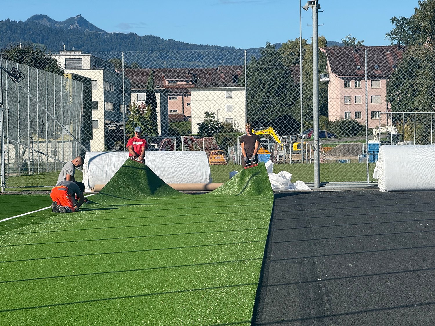Sportanlage Hofmatt: Der neue Kunstrasen wird von den Fachleuten Bahn für Bahn verlegt.